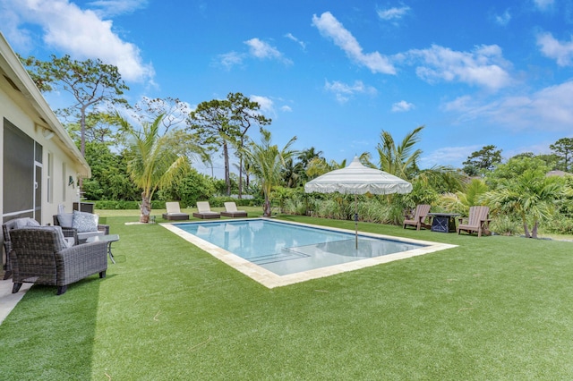 pool with a lawn and a patio area