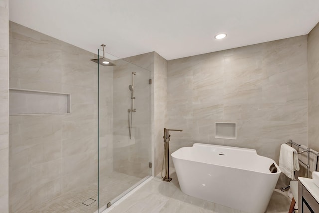 181 Cape Pointe Cir, Jupiter, FL 33477 - full bathroom featuring tile walls, a shower stall, a soaking tub, marble tiled floors, and vanity