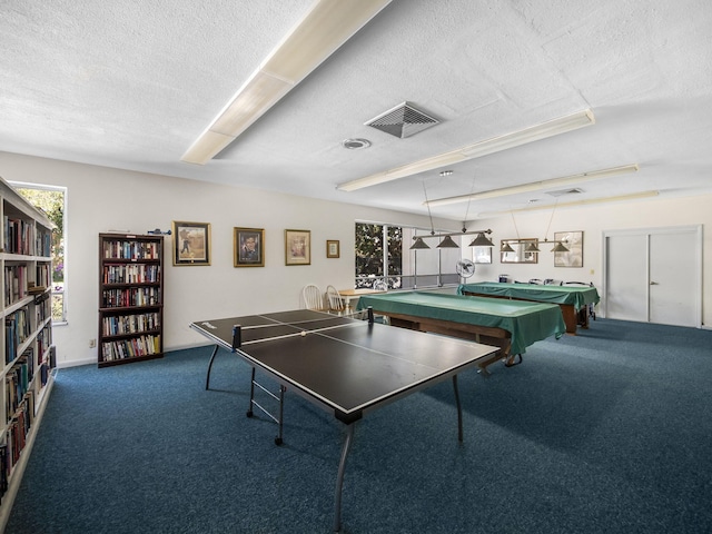 rec room with a textured ceiling, carpet flooring, and visible vents