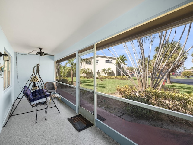 sunroom featuring ceiling fan