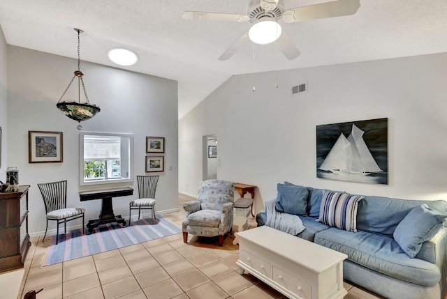 living room featuring light tile patterned floors, baseboards, visible vents, ceiling fan, and vaulted ceiling