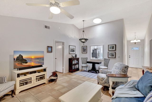 living area with lofted ceiling, light tile patterned floors, a ceiling fan, and visible vents