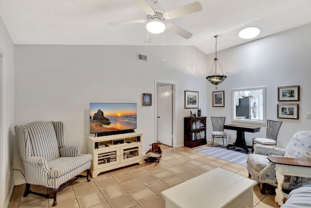 interior space with light tile patterned floors, visible vents, ceiling fan, and vaulted ceiling