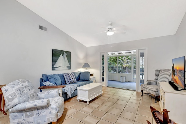 living area featuring ceiling fan, visible vents, light tile patterned flooring, and vaulted ceiling