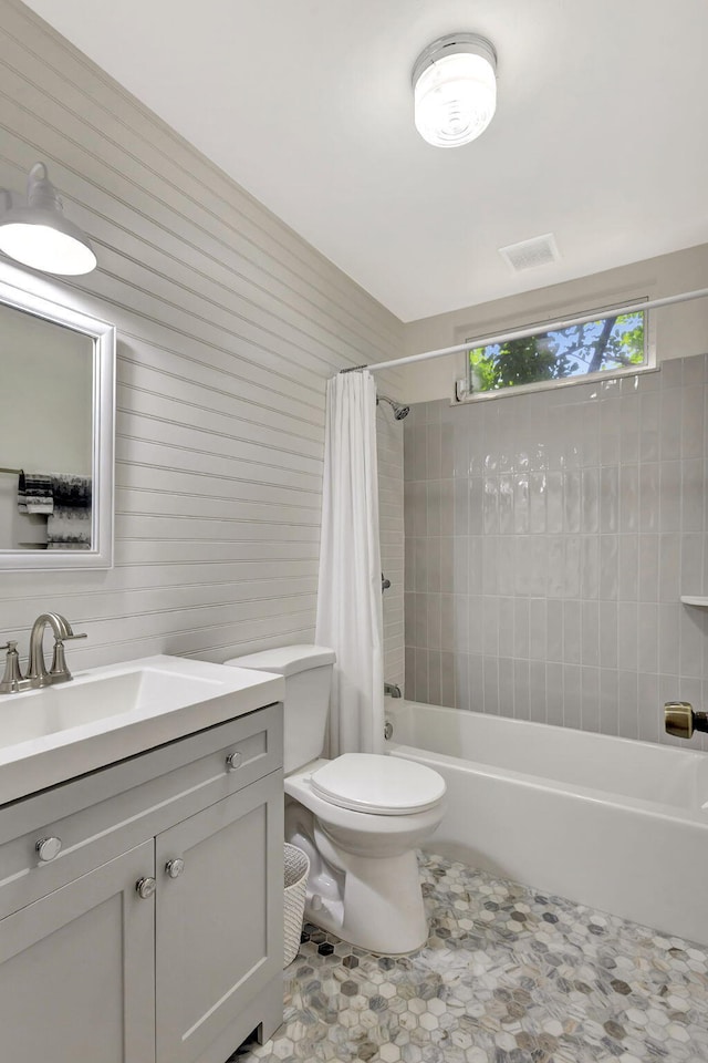 bathroom with visible vents, toilet, vanity, and shower / bath combo