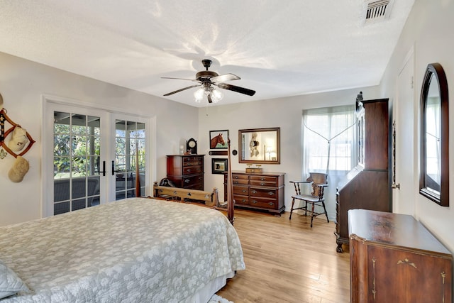 bedroom with visible vents, multiple windows, french doors, and access to outside