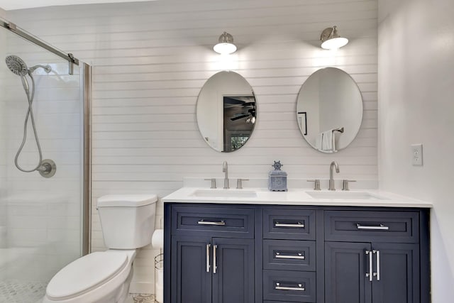 full bath with double vanity, a stall shower, toilet, and a sink