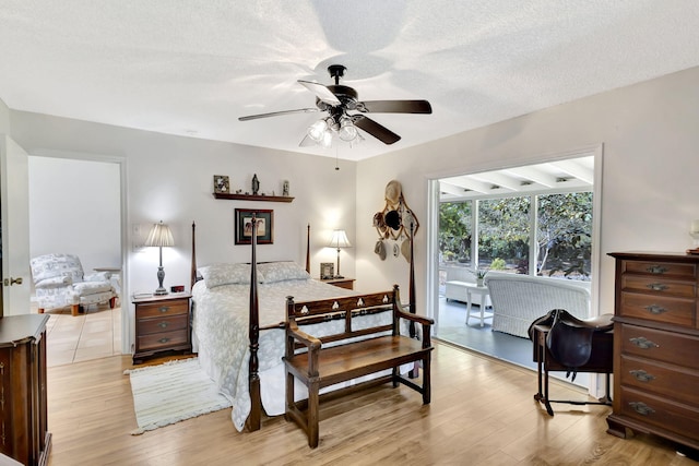 bedroom with light wood-style floors and a textured ceiling