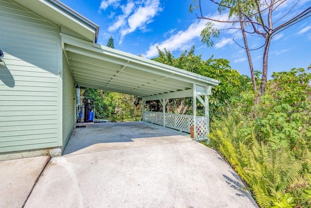 view of vehicle parking with an attached carport and driveway