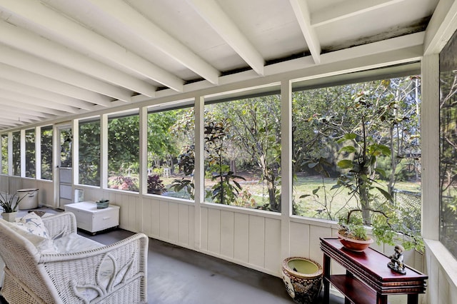 sunroom featuring beamed ceiling