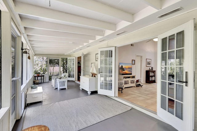 sunroom featuring beam ceiling, french doors, and visible vents