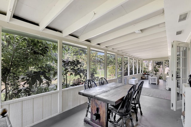 sunroom / solarium featuring visible vents and vaulted ceiling with beams