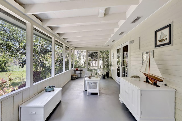 sunroom / solarium with visible vents and lofted ceiling with beams