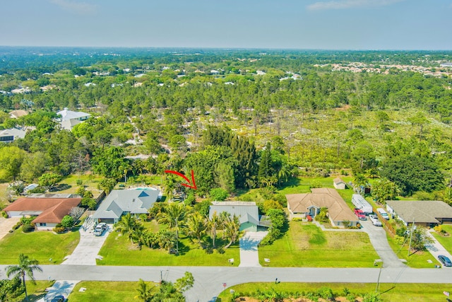 birds eye view of property featuring a residential view and a forest view