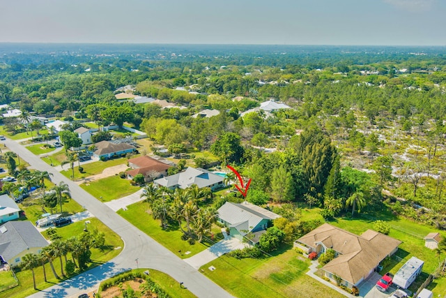 birds eye view of property with a forest view and a residential view