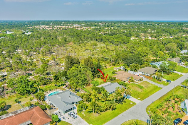 birds eye view of property featuring a wooded view