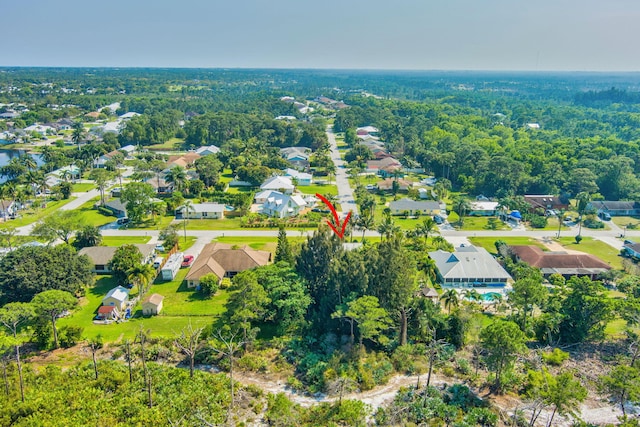 birds eye view of property featuring a residential view and a wooded view