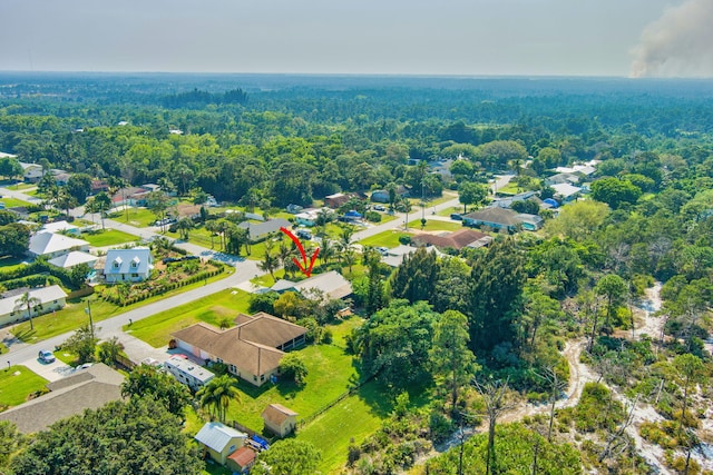 birds eye view of property featuring a forest view and a residential view