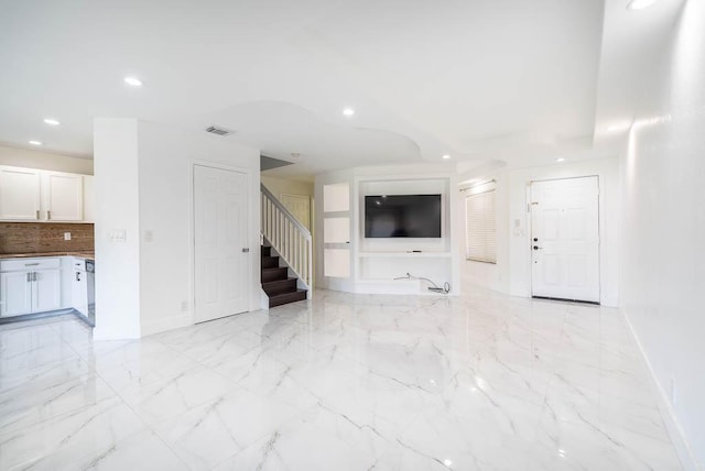 unfurnished living room featuring visible vents, marble finish floor, recessed lighting, baseboards, and stairs