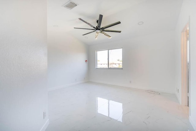 spare room with a ceiling fan, baseboards, visible vents, lofted ceiling, and marble finish floor