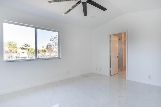 spare room featuring marble finish floor, a ceiling fan, baseboards, and vaulted ceiling