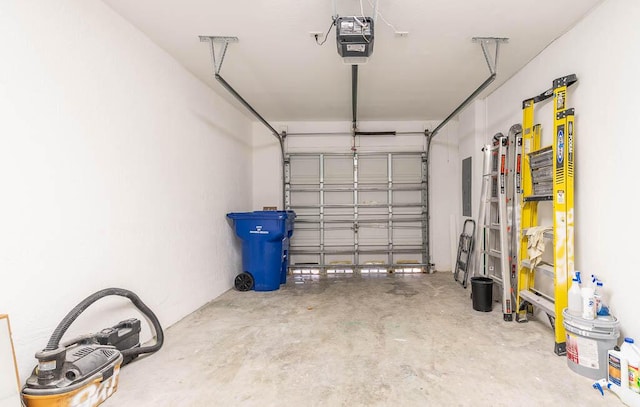 garage with electric panel and a garage door opener