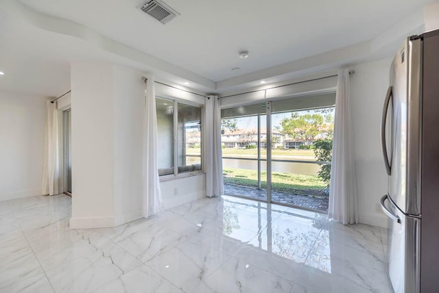 unfurnished room featuring visible vents, a water view, marble finish floor, recessed lighting, and baseboards