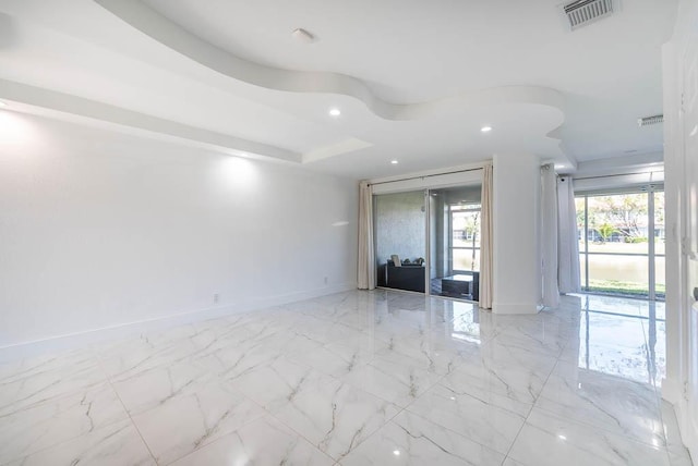 empty room featuring recessed lighting, visible vents, marble finish floor, and baseboards