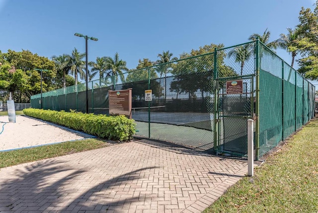 view of sport court with fence and a gate