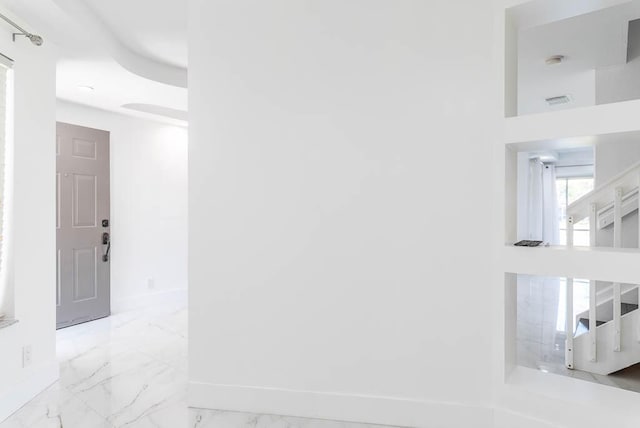 interior space with visible vents, baseboards, and marble finish floor