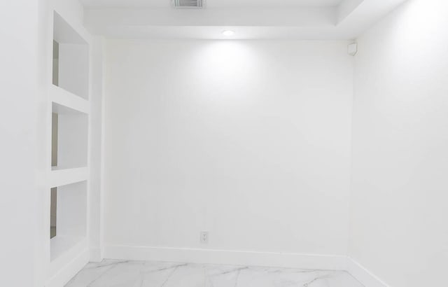 spare room with visible vents, marble finish floor, and baseboards