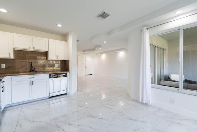 kitchen with dishwashing machine, marble finish floor, white cabinetry, and visible vents