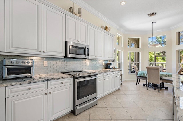 kitchen with stainless steel appliances, white cabinetry, visible vents, tasteful backsplash, and crown molding