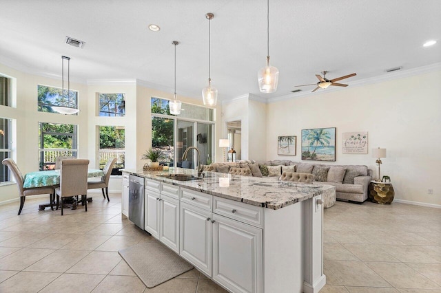 kitchen with visible vents, stainless steel dishwasher, ornamental molding, open floor plan, and a sink