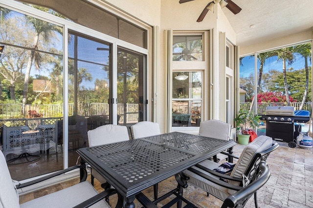 sunroom / solarium with a ceiling fan