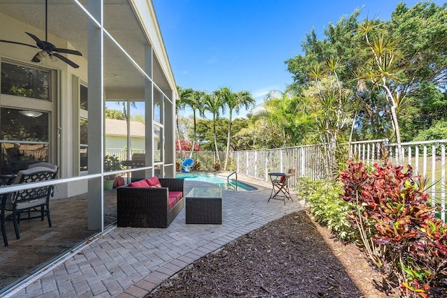 view of patio featuring a ceiling fan, glass enclosure, a fenced backyard, and a fenced in pool