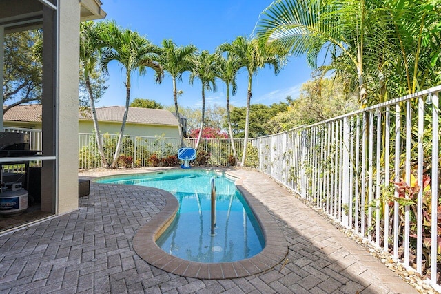 view of pool featuring a patio area, fence, and a fenced in pool