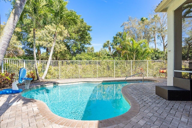 view of swimming pool featuring a patio area, a fenced backyard, and a fenced in pool