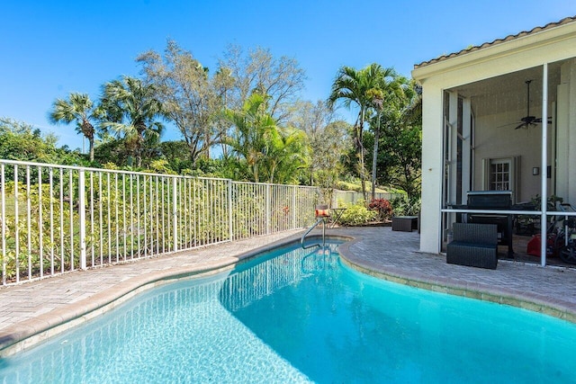 view of swimming pool featuring a patio area, a fenced backyard, ceiling fan, and a fenced in pool