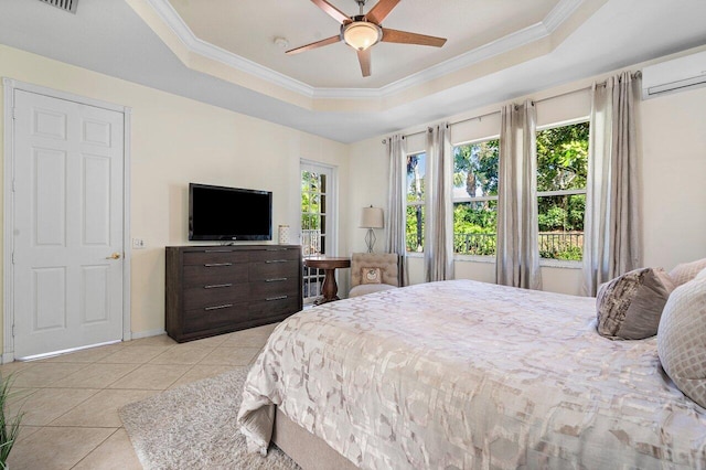 bedroom featuring light tile patterned floors, an AC wall unit, ornamental molding, and a raised ceiling