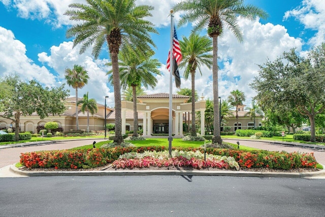 view of building exterior with curved driveway