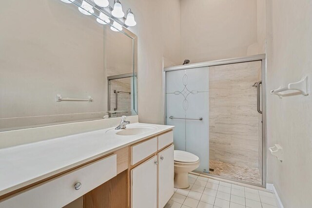 bathroom with tile patterned flooring, baseboards, and vanity