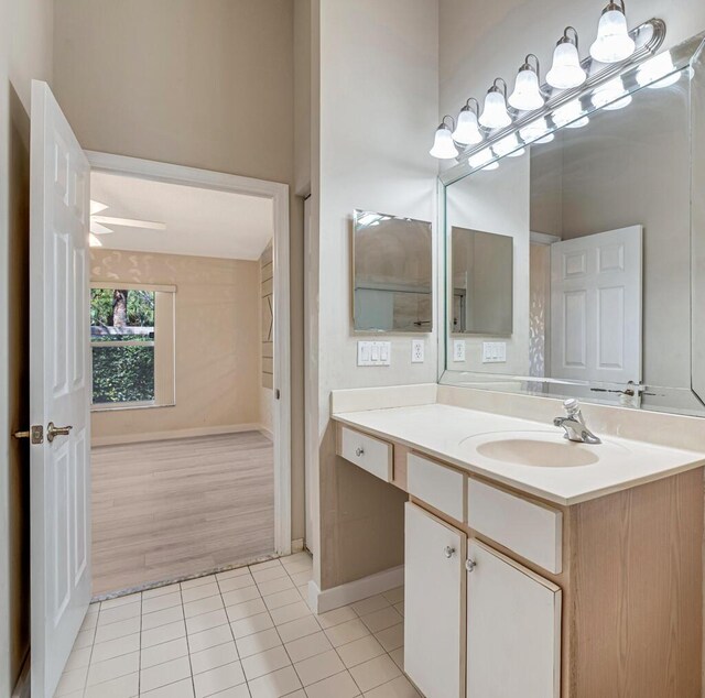 empty room with light tile patterned floors, a textured ceiling, baseboards, and a ceiling fan