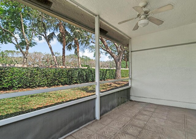 property entrance with ceiling fan and stucco siding