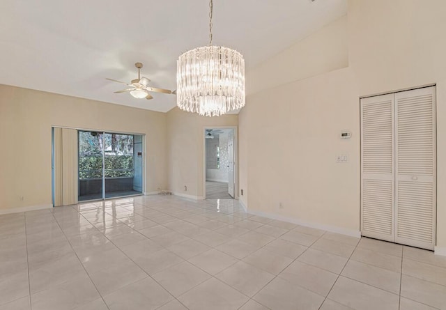 empty room featuring light tile patterned floors, baseboards, high vaulted ceiling, and ceiling fan with notable chandelier