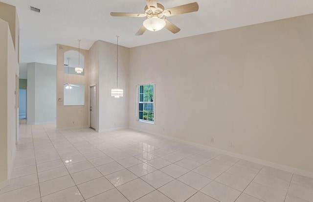 unfurnished room with a ceiling fan, visible vents, baseboards, and light tile patterned floors