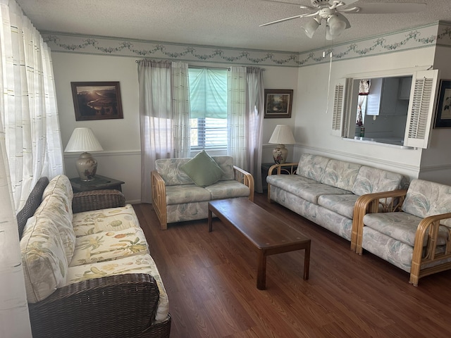 living room with a ceiling fan, a textured ceiling, and wood finished floors