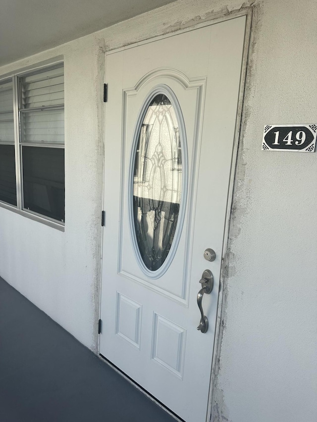 property entrance with stucco siding