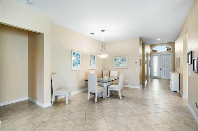 dining room featuring light tile patterned flooring, baseboards, and visible vents