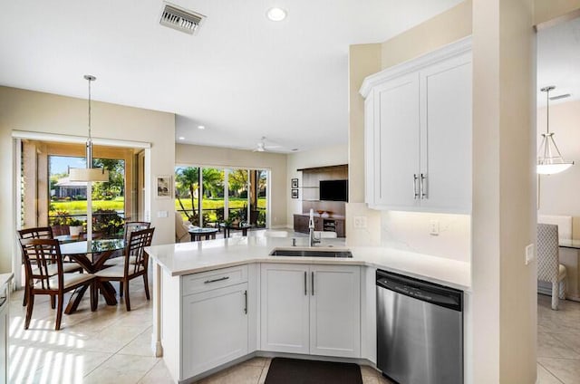 kitchen featuring visible vents, a peninsula, a sink, light countertops, and stainless steel dishwasher